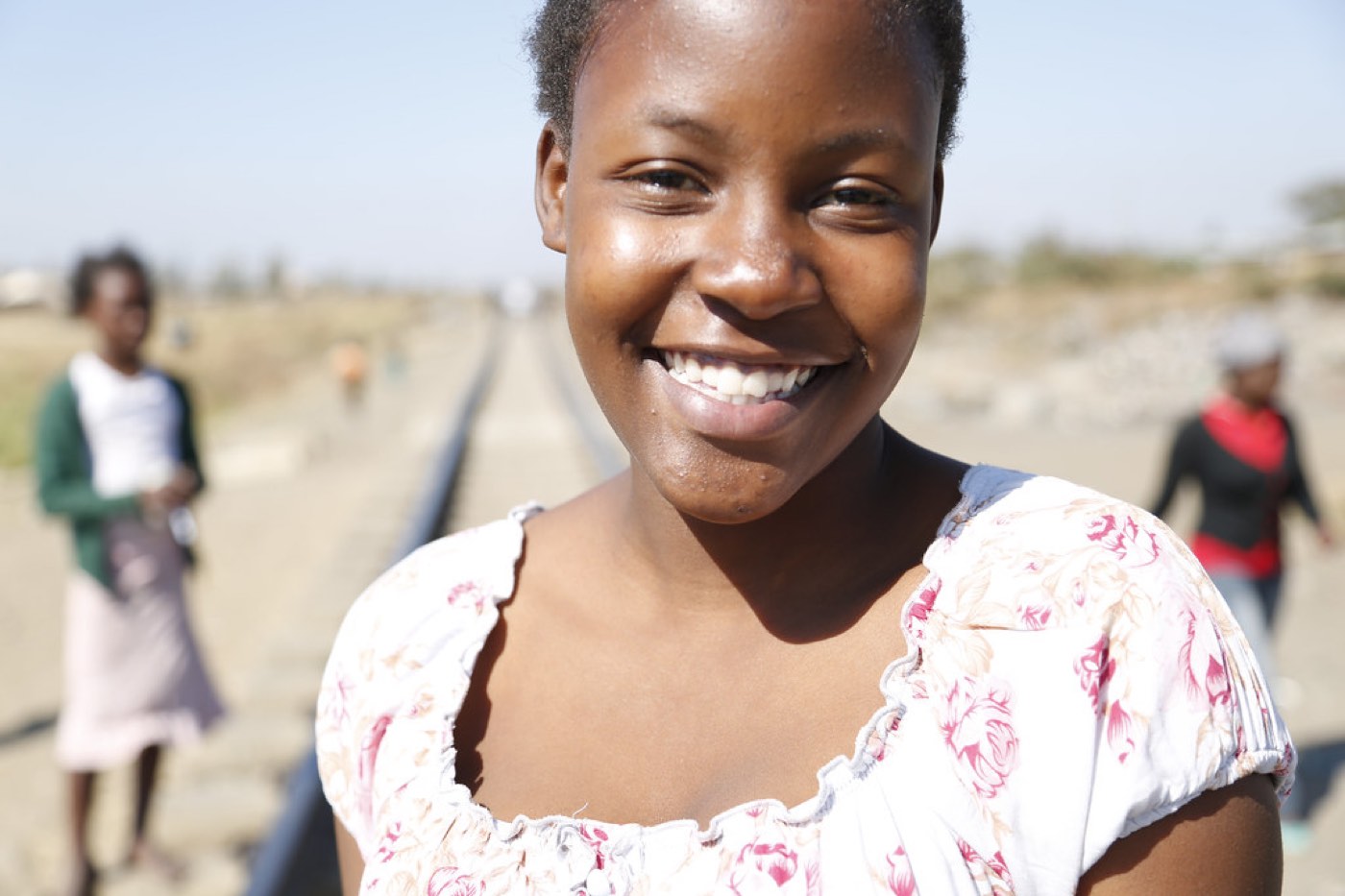 A young woman smiling during a community empowerment programme